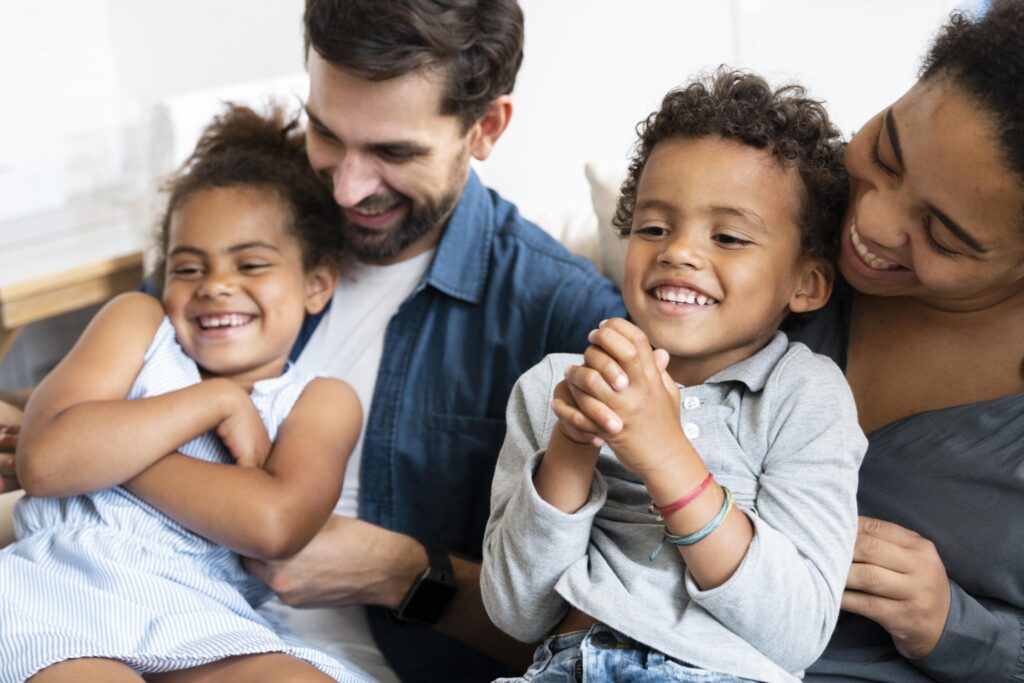 Family with two children laughing.